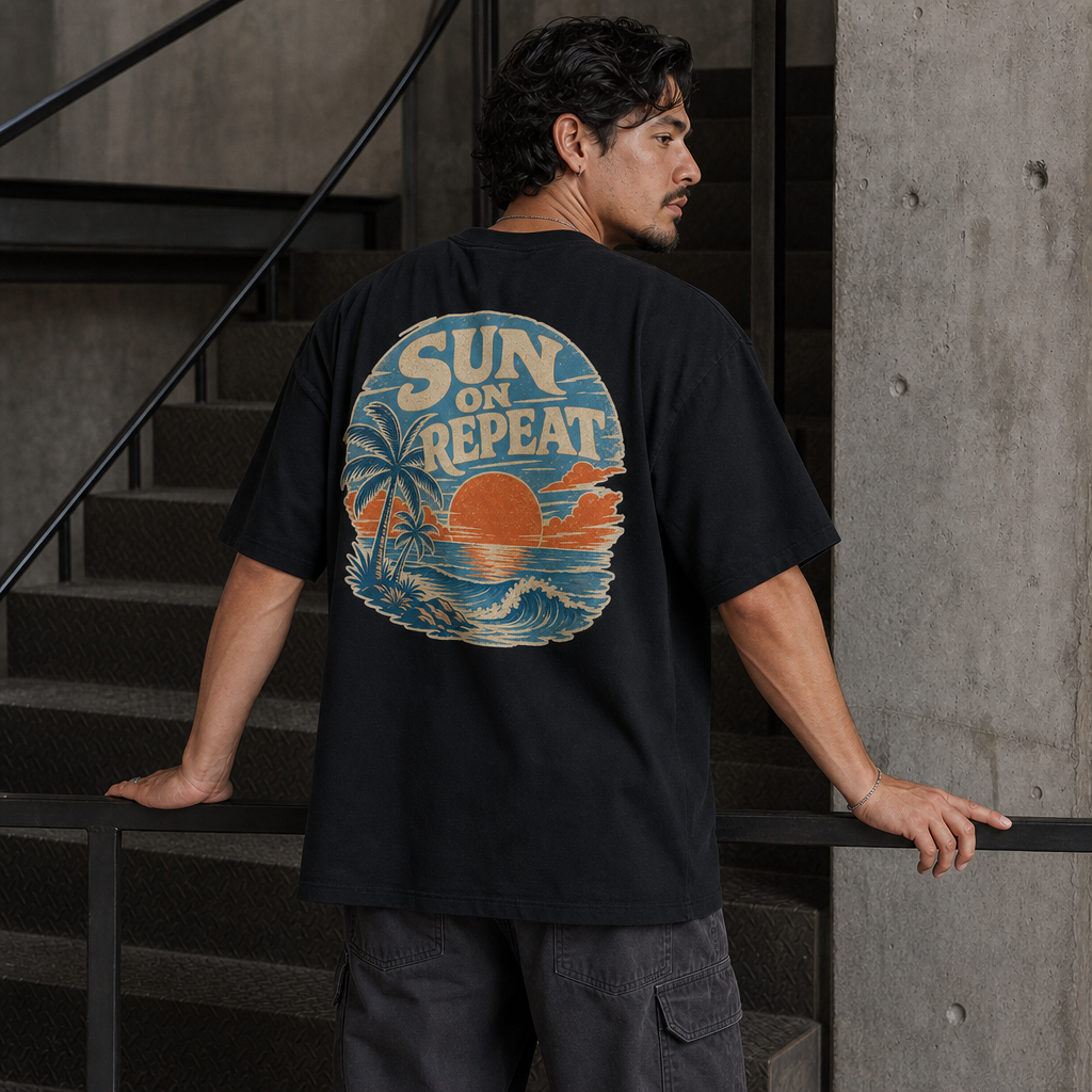Sun On Repeat Oversized Tee in Black – back view worn by an adult man