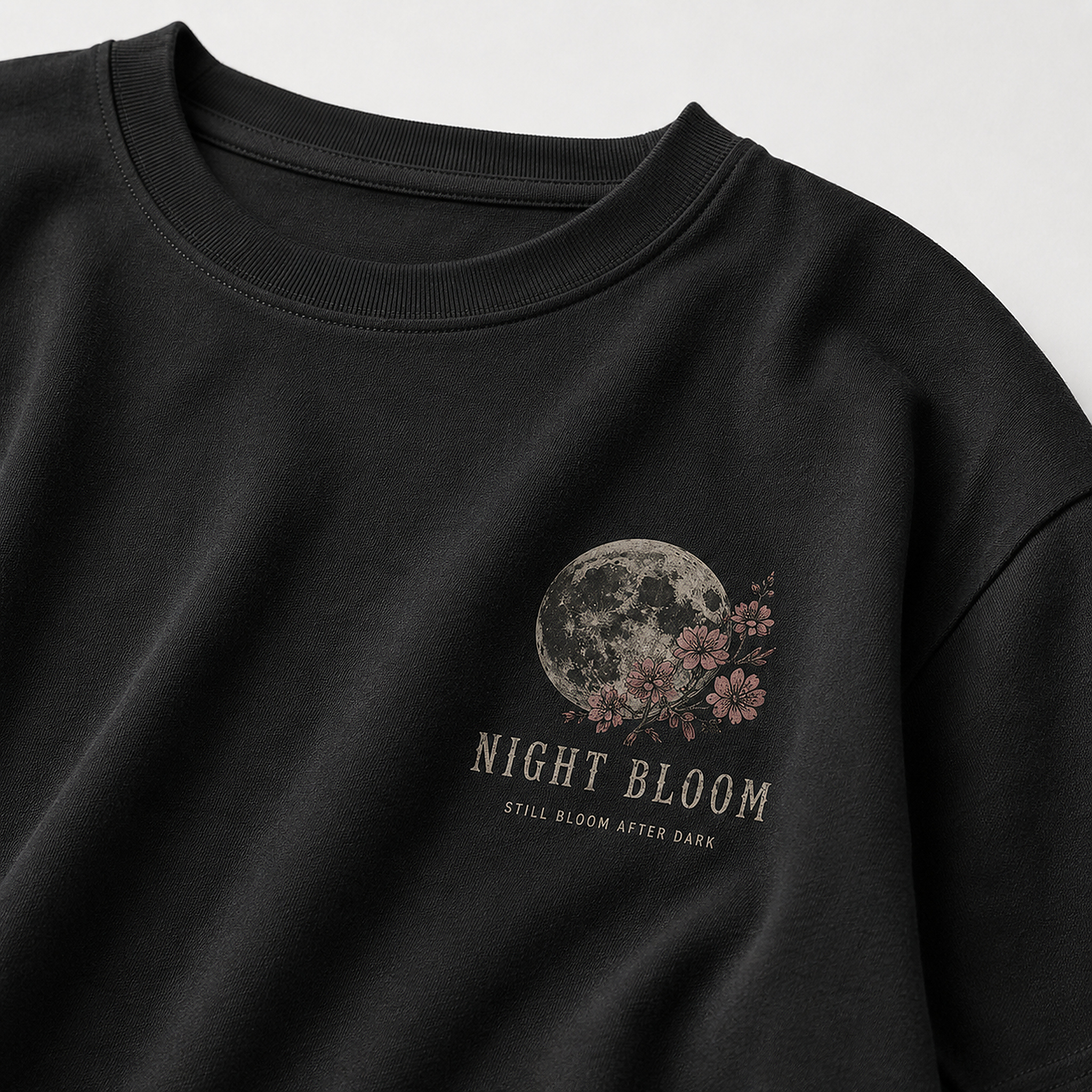 Close-up of Night Bloom Tee in Black showing fabric, print and stitching