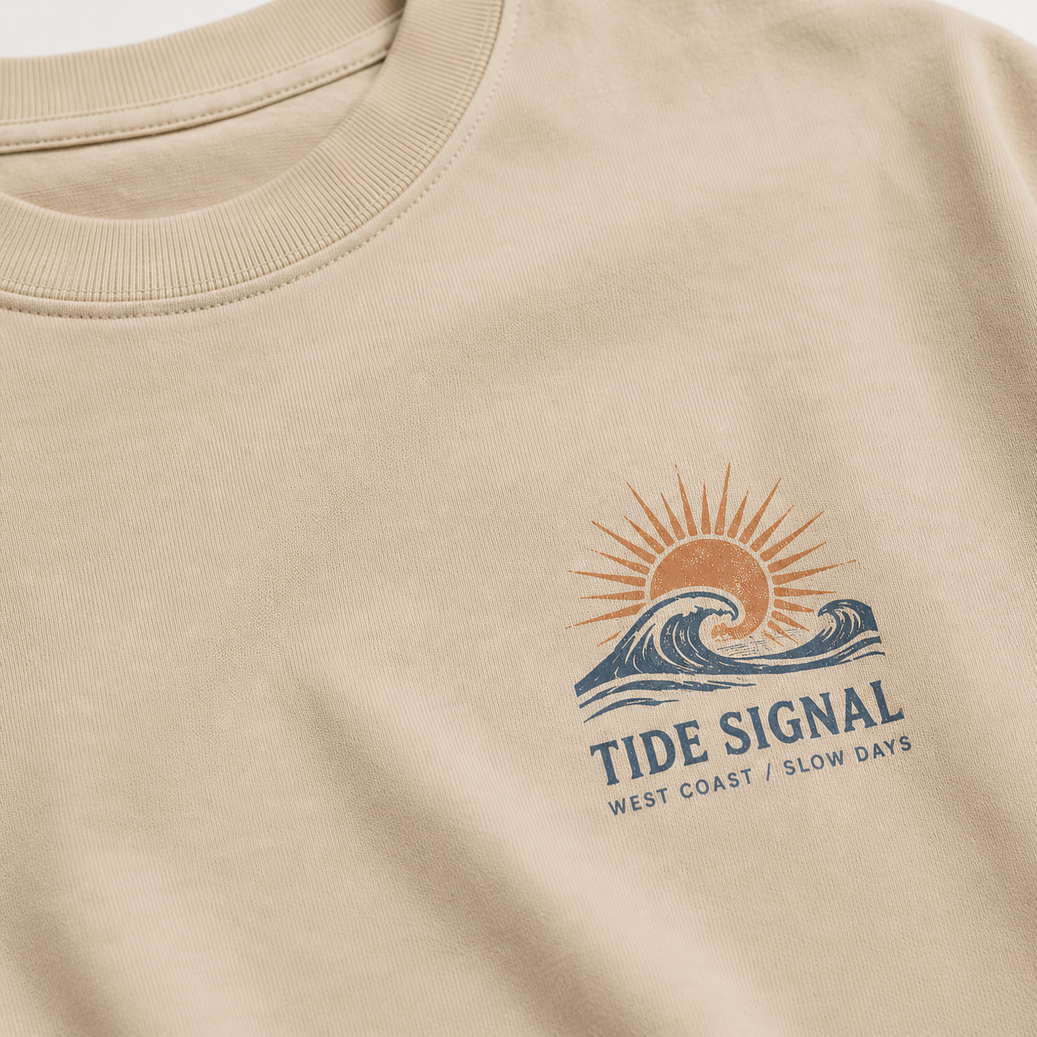 Close-up of Tide Signal Tee in Sand showing fabric, print and stitching