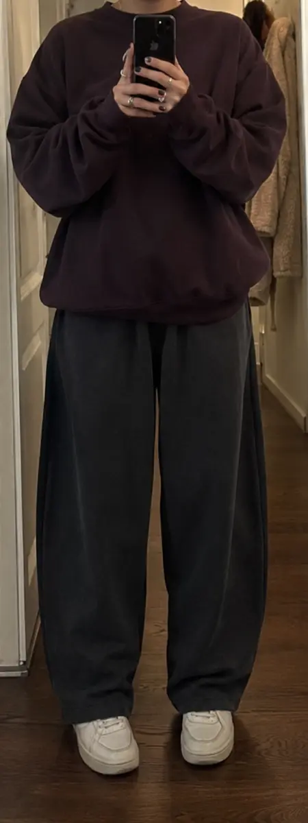 Phone-style hallway mirror photo of wide-leg charcoal joggers and a plum oversized sweatshirt